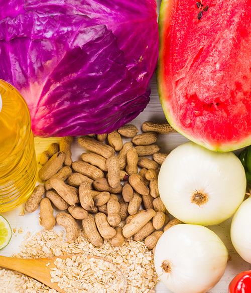 Variety of food including oil, red cabbage, watermelon, peanuts, and oats.