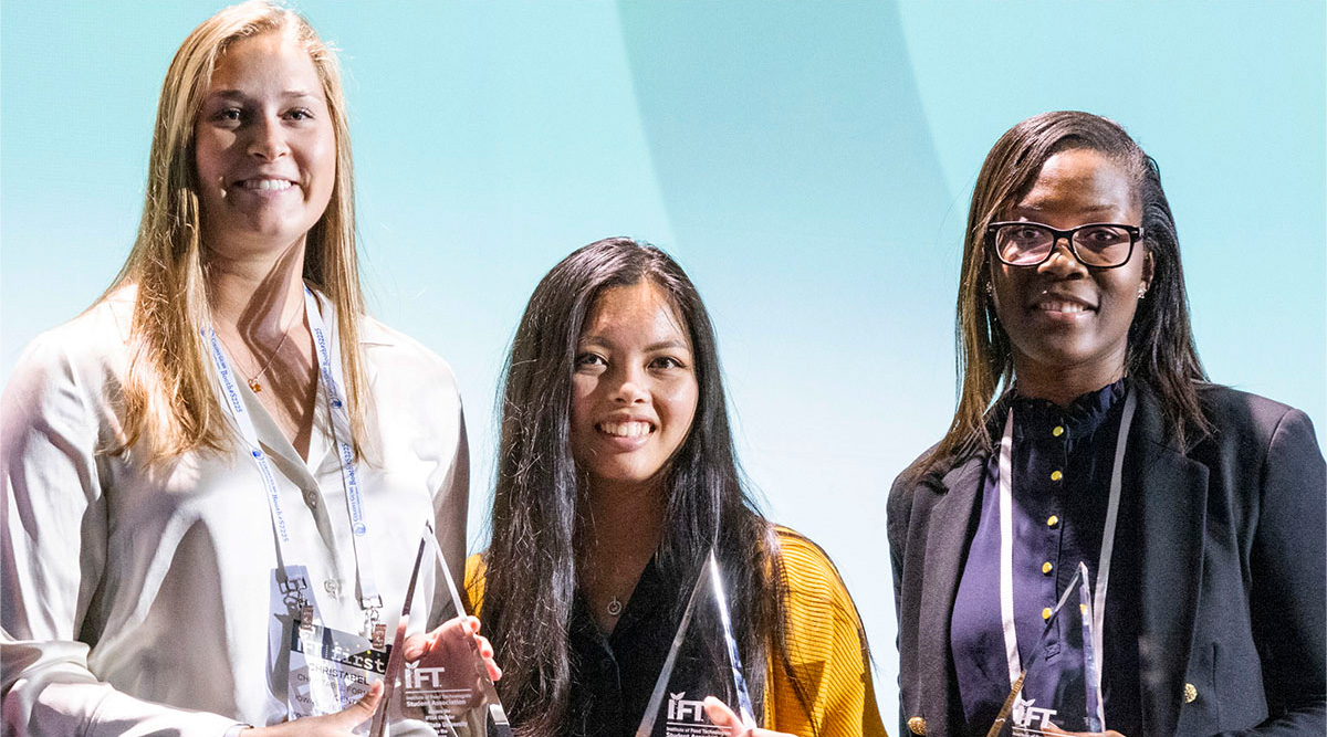 IFT Student Chapters three female students smiling and holding awards