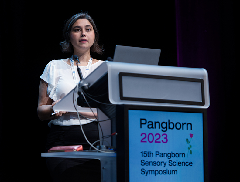 Laura Coelho discusses her EmoMap research at a symposium. 