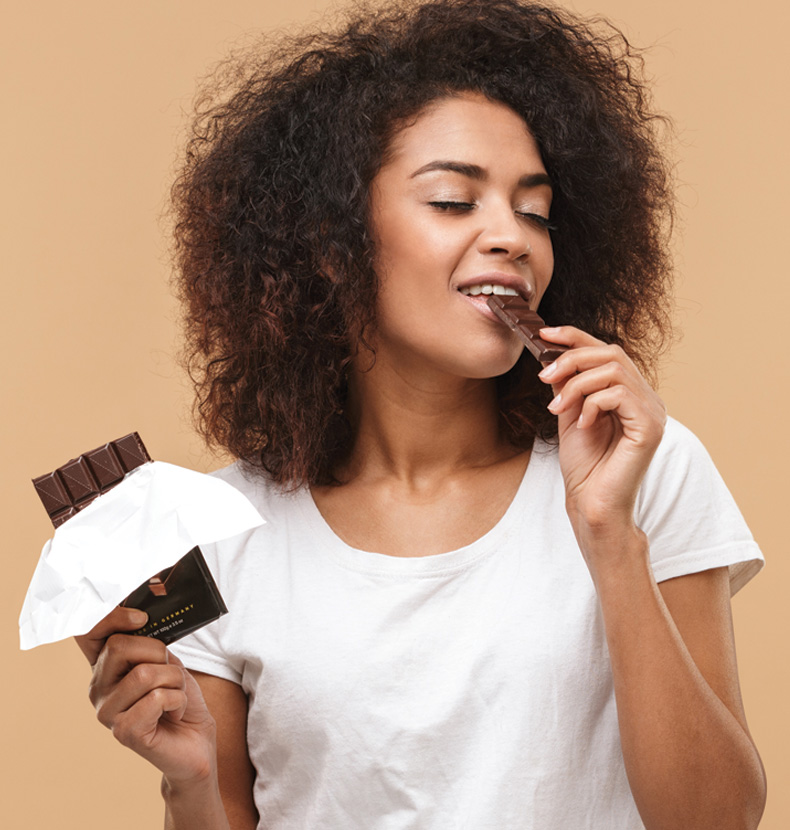 Woman enjoying a chocolate bar
