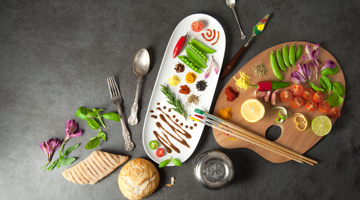 Artful presentation of fresh ingredients on a plate and paint palette with paint brushes.