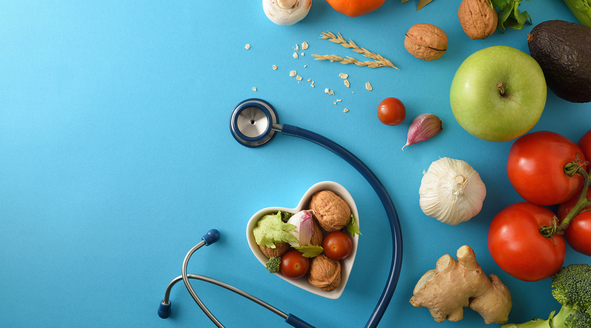 Omnivore logo. A heart-shaped bowl of food surrounded by a stethoscope and a variety of produce