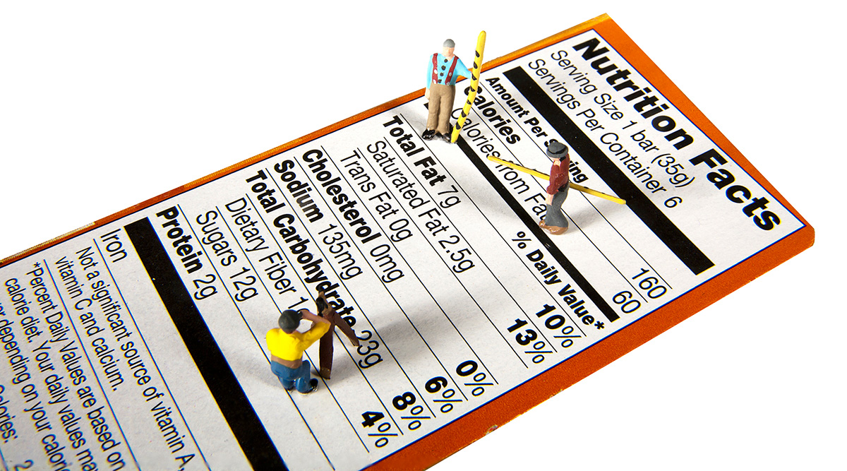 A nutrition facts label with toy men standing on top.
